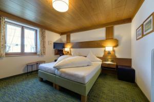 圣安东阿尔贝格加姆伯格酒店的一间卧室,卧室内配有一张大床