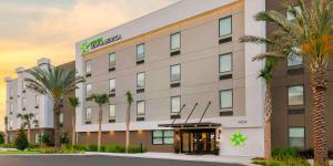 桑福德Extended Stay America Premier Suites - Orlando - Sanford的棕榈树酒店前方的 ⁇ 染
