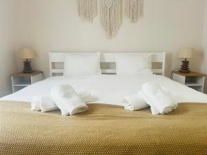 奥比多斯Casa Sonia Great location Quiet area Easy access的一张带毛巾的白色床和两盏灯