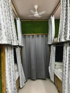 瓦拉纳西Shree Madhvam AC Dormitory的一间卧室配有两张双层床和窗帘