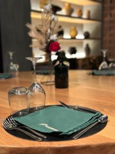 杜兰戈Hotel Ocamiño的一张桌子,一张桌子上摆放着绿色餐巾,放在木桌边