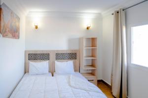 达赫拉PLAYA HOTEL的卧室配有白色的床和窗户。