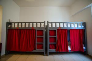 迪拜Lunar Hostel的一间卧室配有两张双层床和红色窗帘