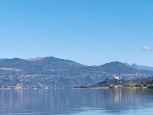 塞斯托卡伦德Lago Maggiore Lake Me Home apartment的一大片水体,背景是群山