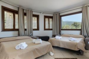 扎费拉纳-埃特内阿Villa Vulcano, tra l'Etna e il mare的酒店客房,配有两张带毛巾的床