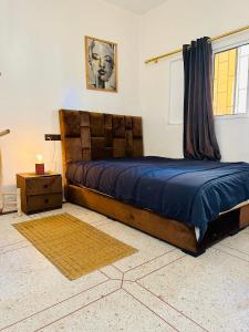 奥瑞尔K11SURF的一间卧室配有一张带蓝色棉被的大床