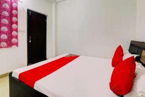 ChinhatOYO Flagship Shine Hotel的卧室配有红色和白色的床和红色枕头