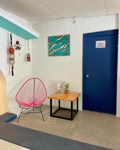 坎昆The Boat House Cancun的一间设有蓝色门、椅子和桌子的房间
