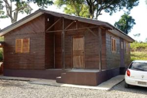 马沙蒂纽Morada do Lago Raio de Sol的一座小型木屋,前面设有停车位