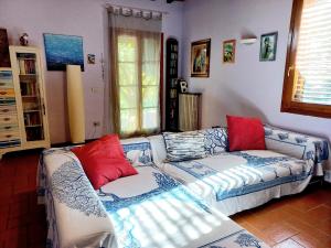 斯坎迪奇Casa Gelso的带沙发和红色枕头的客厅