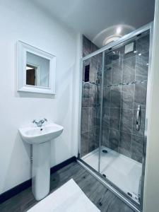 盖茨黑德Stunning 3-Bed Cottage in Gateshead的带淋浴和盥洗盆的白色浴室