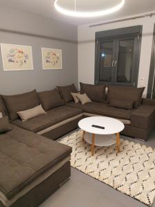 特里卡拉Square Apartments的客厅配有沙发和桌子