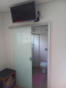三玛丽亚镇Pousada Rural Veredas的一间带卫生间的浴室和墙上的电视