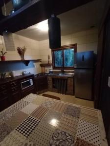 新彼得罗波利斯Casa com vista para o vale - Serra Gaúcha的厨房配有黑色冰箱和桌子