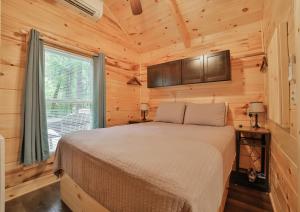 查塔努加Thomas Cabin Forest Tiny Cabin With Hot Tub的小木屋内一间卧室,配有一张床