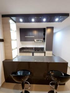 伊察Acogedor departamento en Huacachina的厨房配有两个黑色水槽和台面