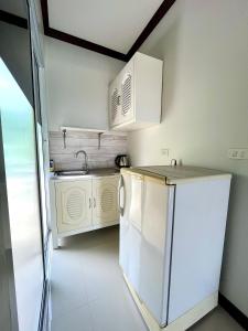 高兰Tan Residence的白色的厨房配有水槽和洗碗机
