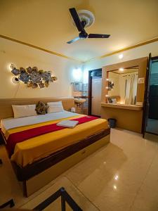 卡兰古特Shradha luxury room的一间卧室配有一张床和吊扇