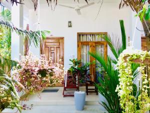 阿鲁甘湾Tropicana Home Stay的一间布满植物和木门的房间