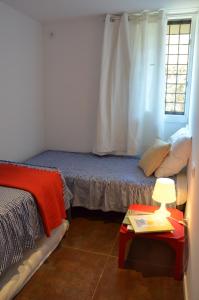 科莱拉Apartment Rovellada Platja的一间卧室配有一张床和一张带台灯的桌子