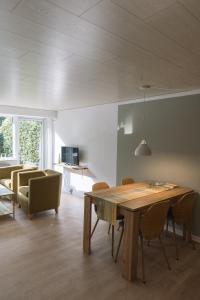 北内伯尔Drømmehus Ferienwohnungen的客厅配有木桌和椅子