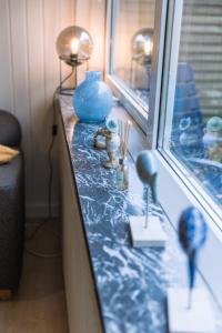 北内伯尔Drømmehus Ferienwohnungen的窗台上带有蓝色花瓶的台面