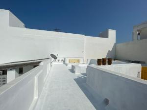 蓬蒂切里Parambara Heritage的一座白色的建筑,上面有楼梯和锅子
