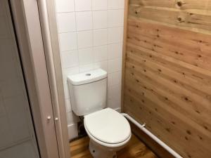 KentCabin 4的浴室配有白色卫生间和木墙
