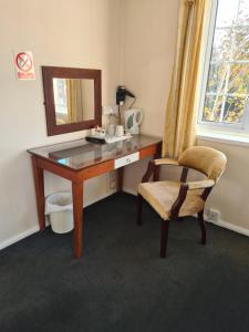 拉格比希尔莫顿庄园酒店的一张桌子,带镜子和椅子