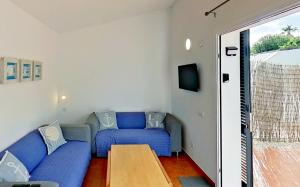 比尼贝卡Apartamento Binibeca Nou Cami de Cavalls的客厅配有蓝色的沙发和桌子