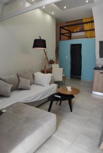 雷夫卡达镇LEFKAS CITY APARTMENTS & SUITES的客厅配有沙发和桌子