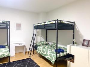 伍珀塔尔Shared Serenity accommodation的一间卧室配有两张双层床和一张书桌