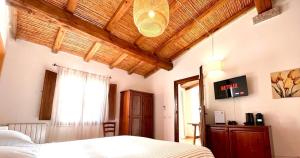 圣特奥多罗李司考匹乡村民宿的一间卧室设有一张床和木制天花板