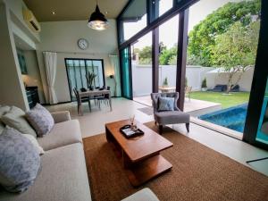 普吉镇Horizon Vista Pool Villa Family Retreat Bangtao的客厅配有沙发和桌子