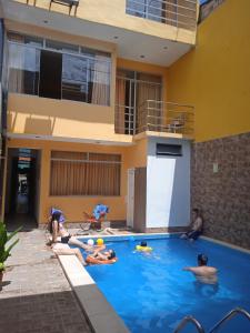 伊基托斯100 RV Apartments Iquitos-Apartamento primer piso con vista a piscina的一群人躺在游泳池里