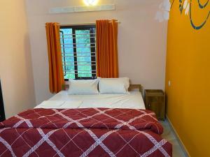 提喀迪Heavenly Stay的一间卧室配有床和橙色窗帘的窗户