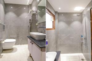 新德里FabHotel La Serene BnB的一间带水槽、淋浴和卫生间的浴室