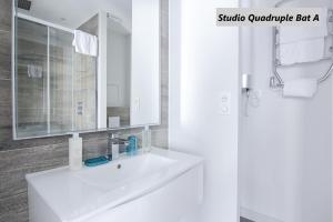 凡尔赛隆科尔路易公寓式酒店的浴室设有白色水槽和镜子