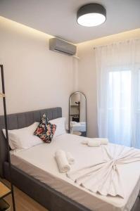 亚历山德鲁波利斯Ivi's Home Alexandroupoli的卧室配有一张带镜子的白色大床