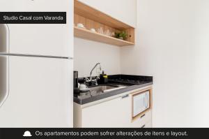 圣保罗Charlie Harmonia Vila Madalena的白色的厨房配有冰箱和微波炉。