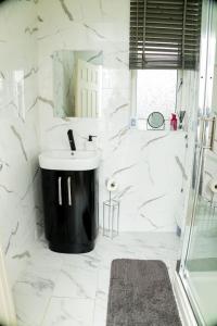 曼彻斯特Dynasty Lodge Manchester - Alison Kelly close的白色的浴室设有水槽和镜子