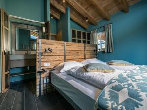 莱奥冈Chalet Schneelöwe L的一间卧室设有两张床,拥有蓝色的墙壁。