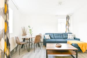 米卢斯Evasion Mulhousienne的客厅配有蓝色的沙发和桌子