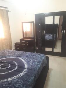 Sohna's Paradise Residence的一间卧室配有一张床、梳妆台和镜子