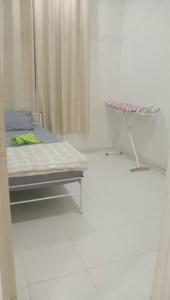 PakaHomestay Taman Tiara Paka的一间医院间,配有一张床铺和一张桌子