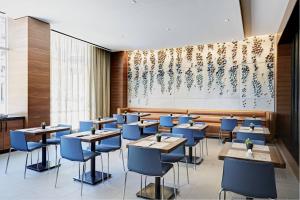 坦培凤凰城天普/市中心万豪AC酒店的一间配备有桌子和蓝色椅子的用餐室