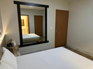 巴西利亚Pousada do Atleta的一间卧室配有一张床和一面大镜子