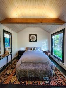 派恩希尔Belleayre Lodge的一间卧室设有一张大床和两个窗户。