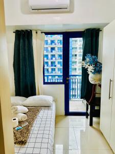 马尼拉Sea Residences - Property Val Alano 0995-448-8872的小房间设有床和窗户
