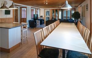 雪平斯维克Amazing Home In Kpingsvik With Sauna的用餐室以及带白色桌椅的起居室。